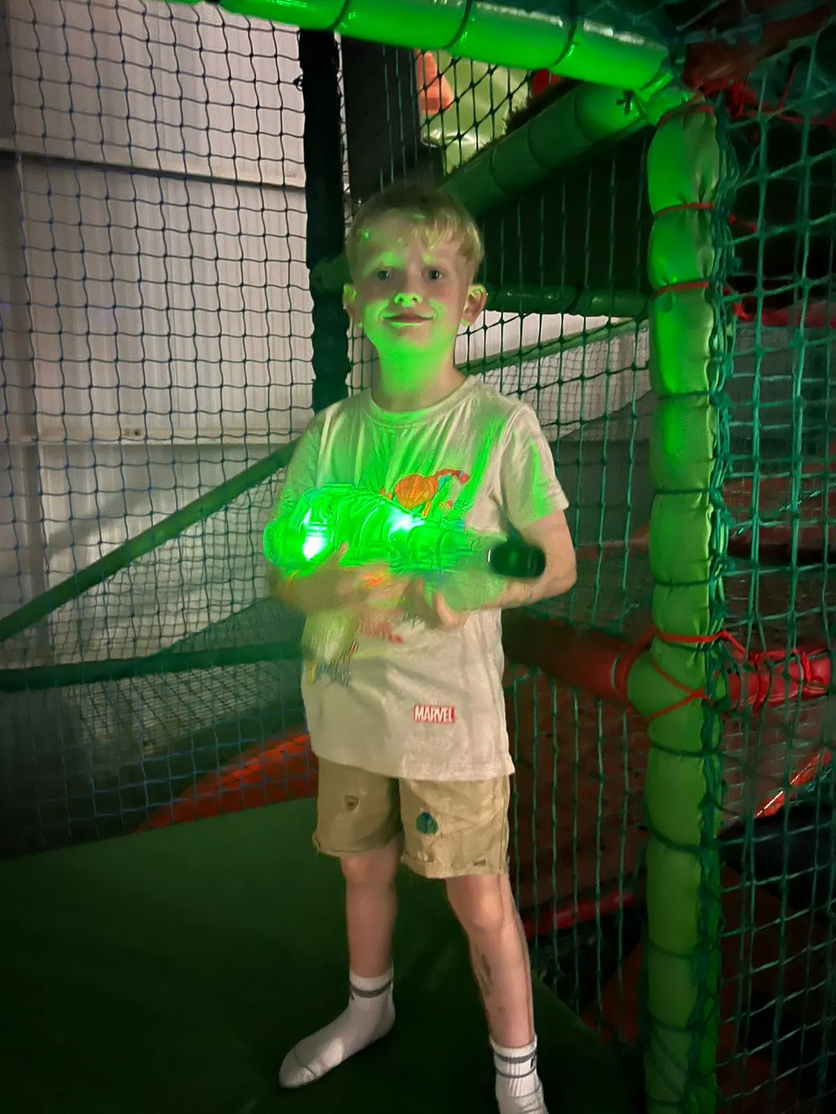 Child playing inside padded soft-play frame at Robin Hood Soft Play