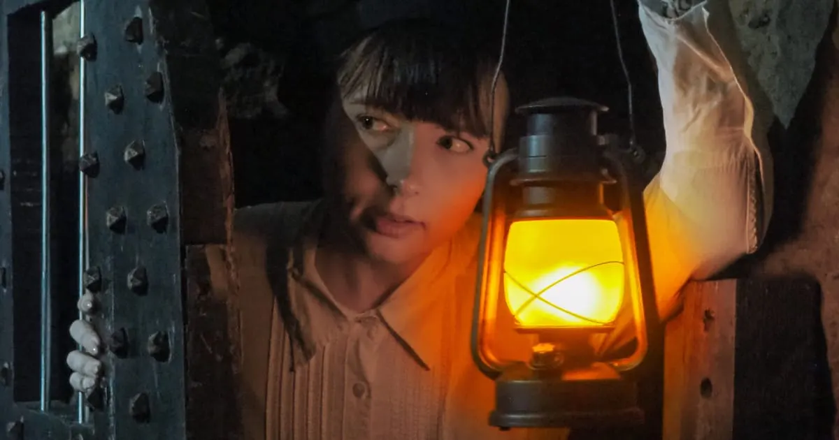 Lantern lighting a studded gaol door on Ghosts of the Gaol art