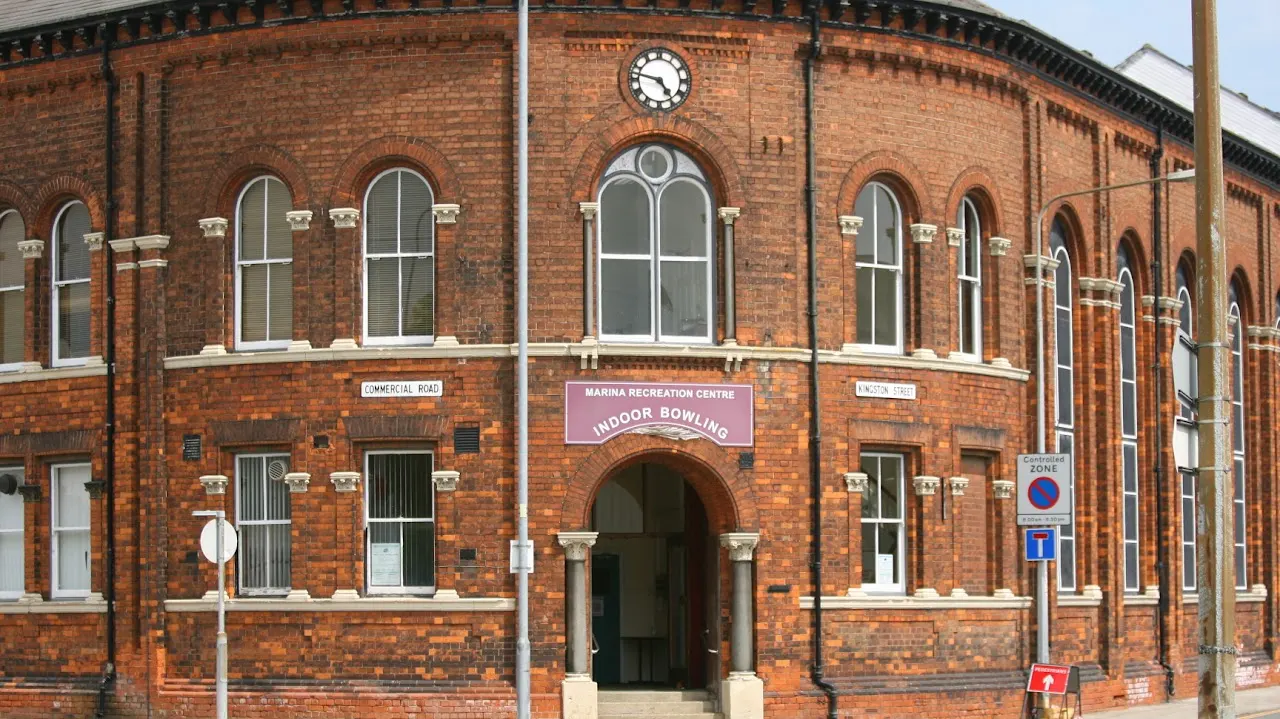 Victorian red-brick building with "Marina Recreation Centre Indoor Bowling" signage above the arched entrance.