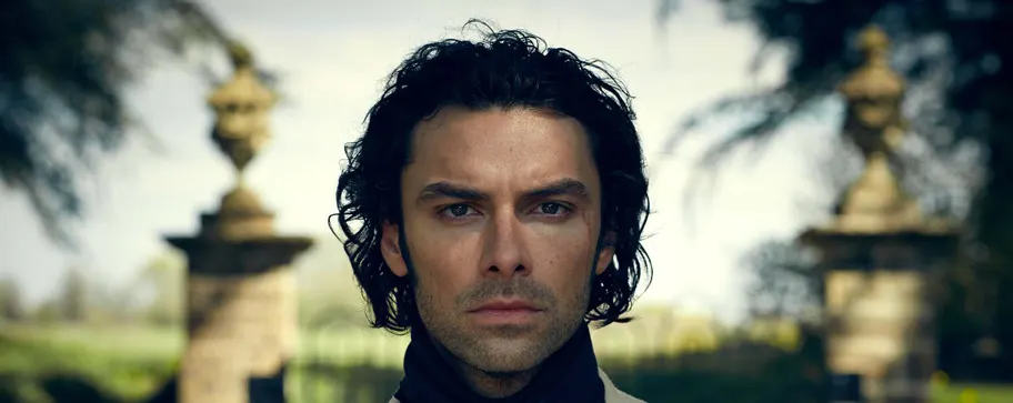 This is a designed graphic, appearing to be a promotional image with an actor's portrait overlaid on a stately home setting with ornamental gates.

GRAPHIC
