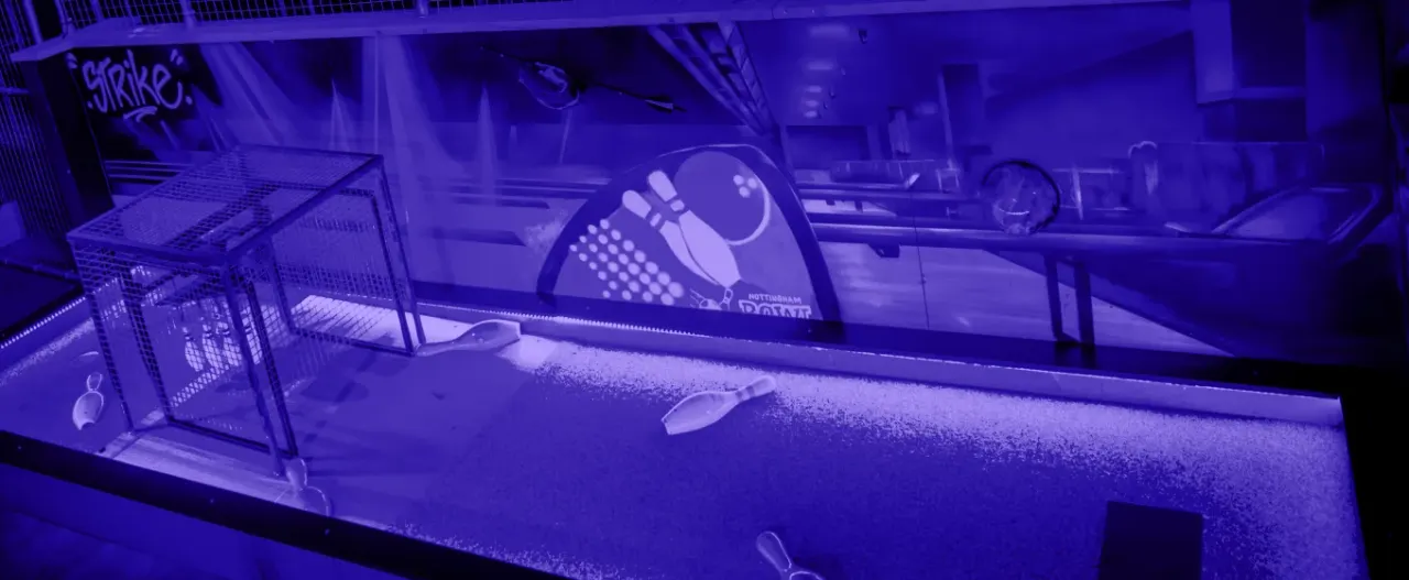 Indoor UV Scrapyard Golf course at Discobowl Nottingham with neon lighting and Nottingham Bowl mural