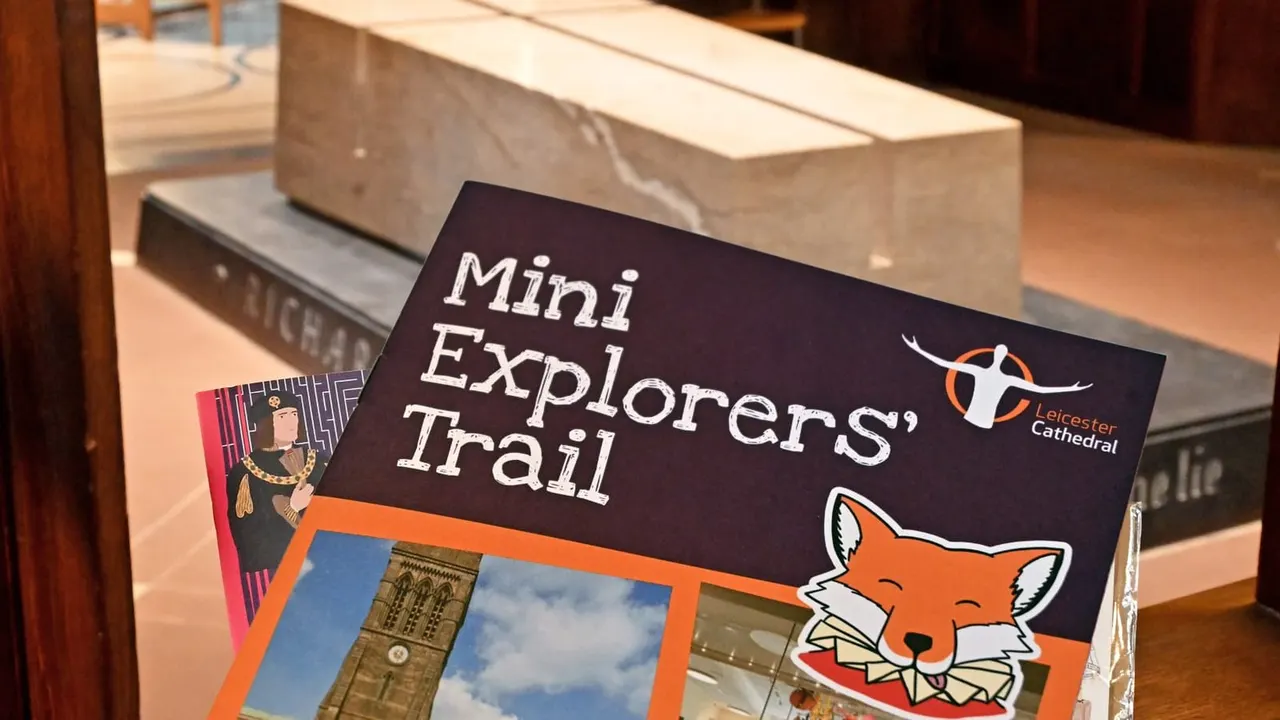 A leaflet for the Mini Explorers' Trail sits on a display counter in an interior space.