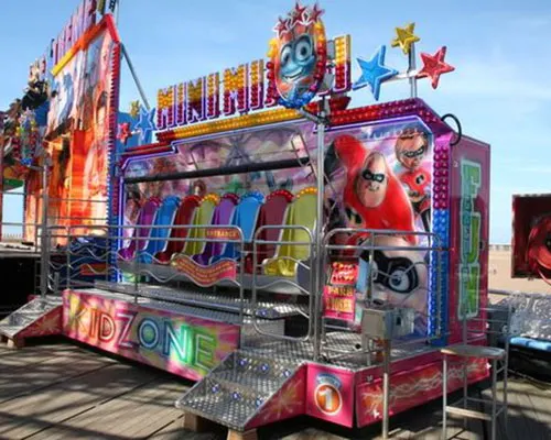 Colourful fairground ride with cartoon character graphics and bright signage at an amusement park.