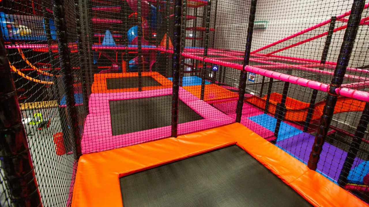 Multi-tier TAG soft play frame with trampolines and pink padding at Lammas