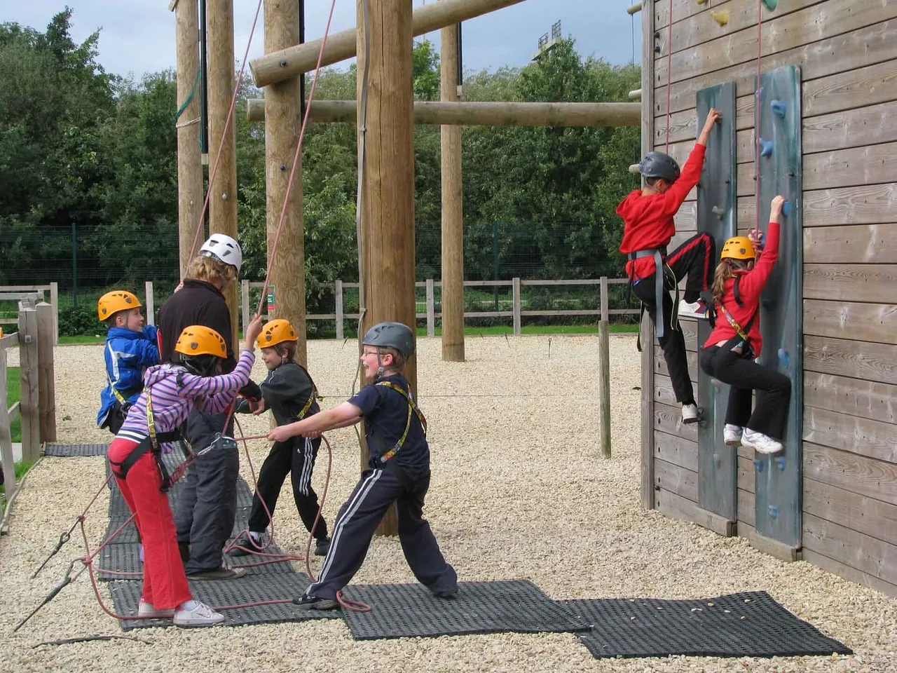 Children climbing the outdoor wall at Leicester Outdoor Pursuits Centre