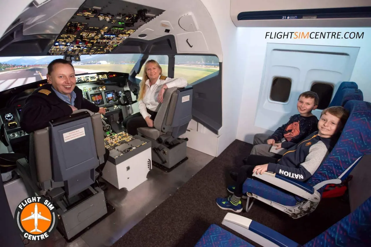 Two adults and two children inside an aircraft flight simulator cockpit and cabin, with visible controls and runway view on screens.