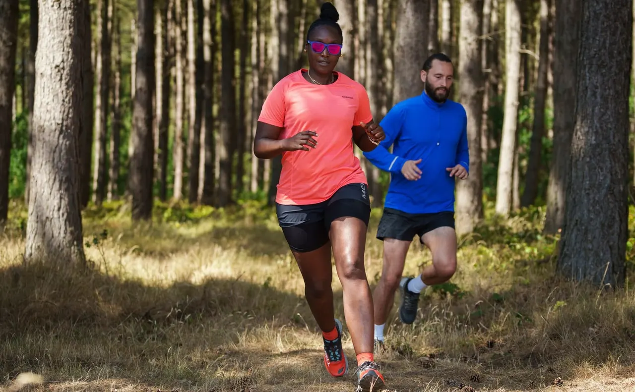 Runners in summer forest