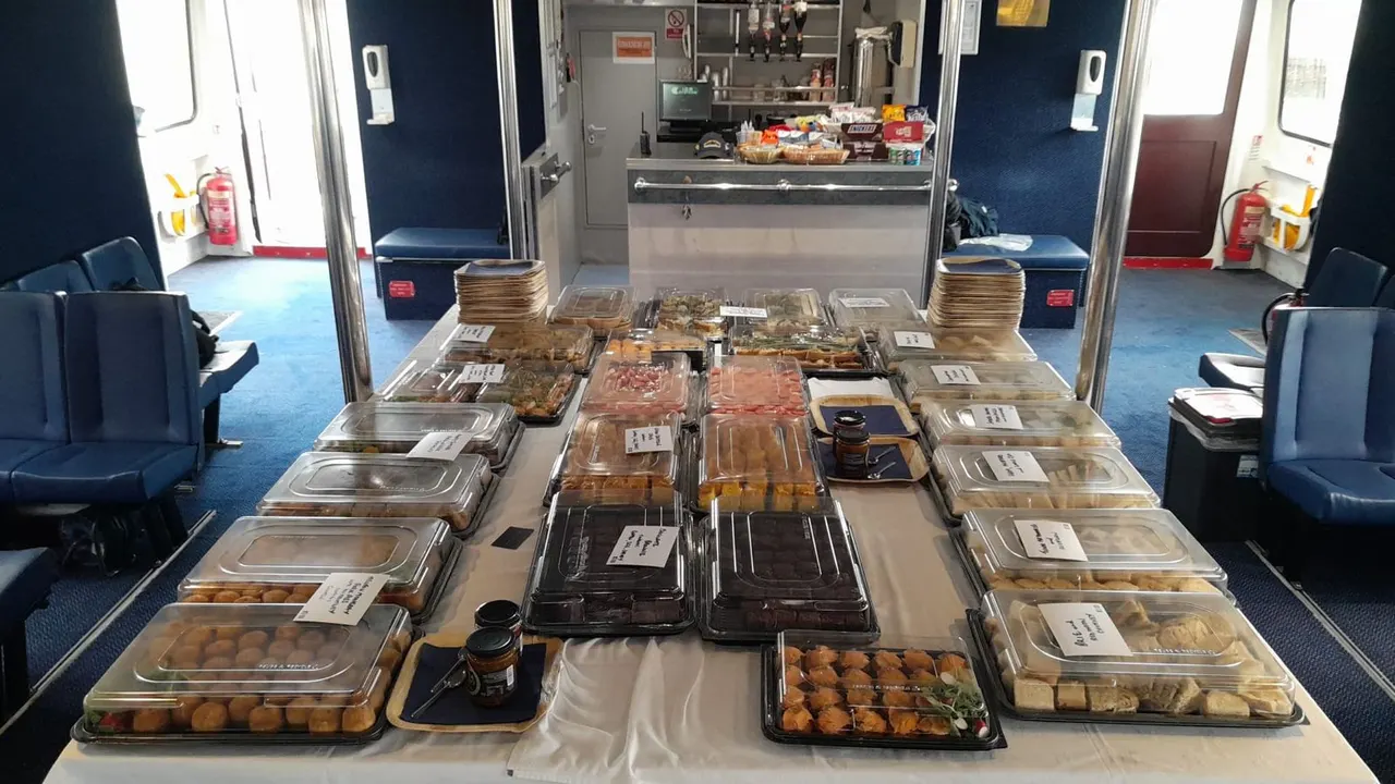 Food service counter on a passenger ferry displaying various packaged meals and snacks.