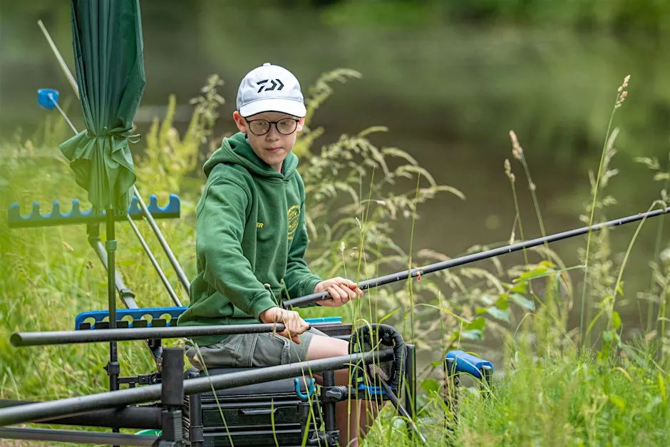 Child learning to fish on a canal bank at Let's Fish Ilkeston