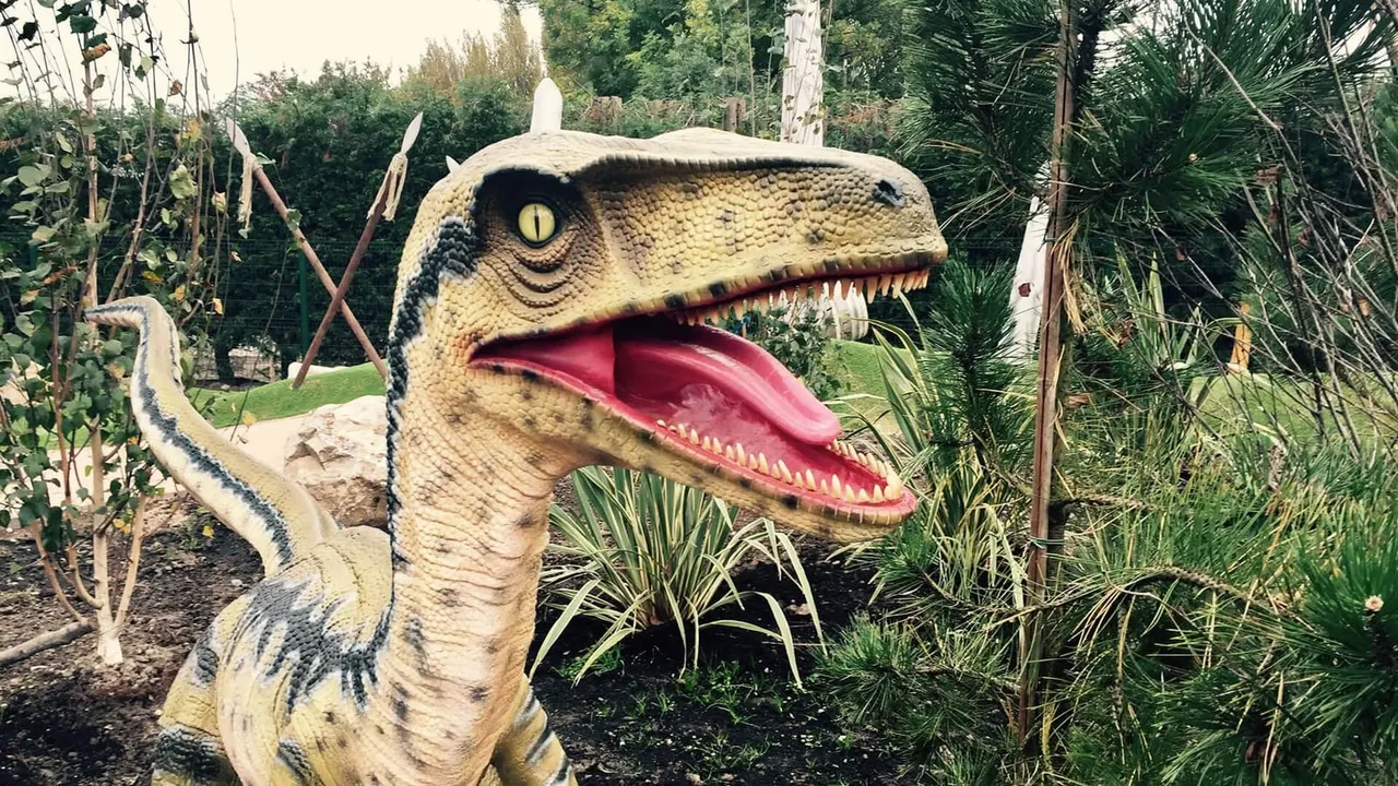 Close-up roaring raptor statue obstacle on Lost World adventure golf