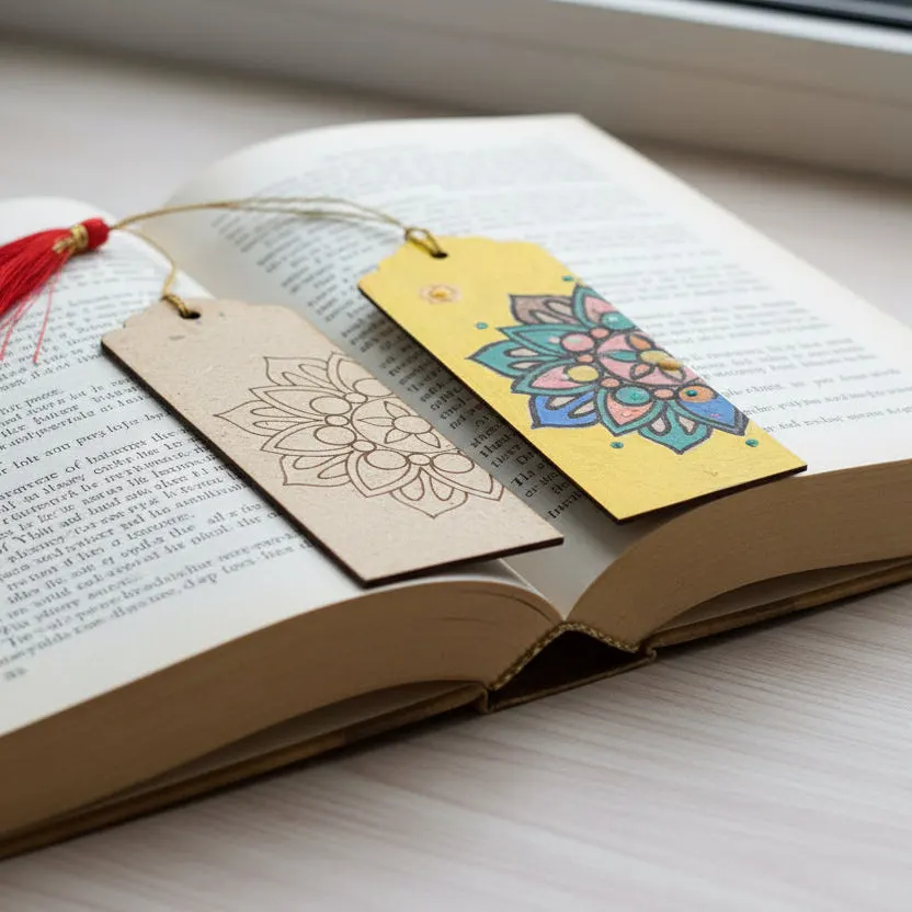 Two decorative bookmarks with mandala designs placed in an open book on a white surface.