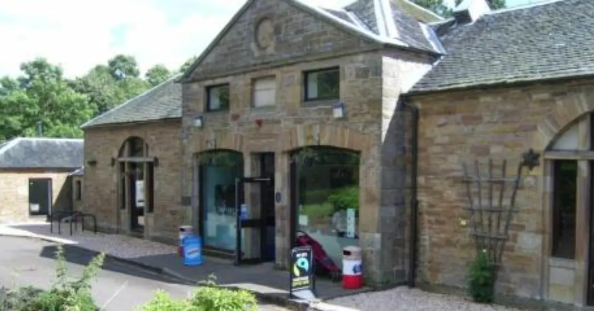 Historic stone buildings with entrance doors and windows at a country park visitor facility.