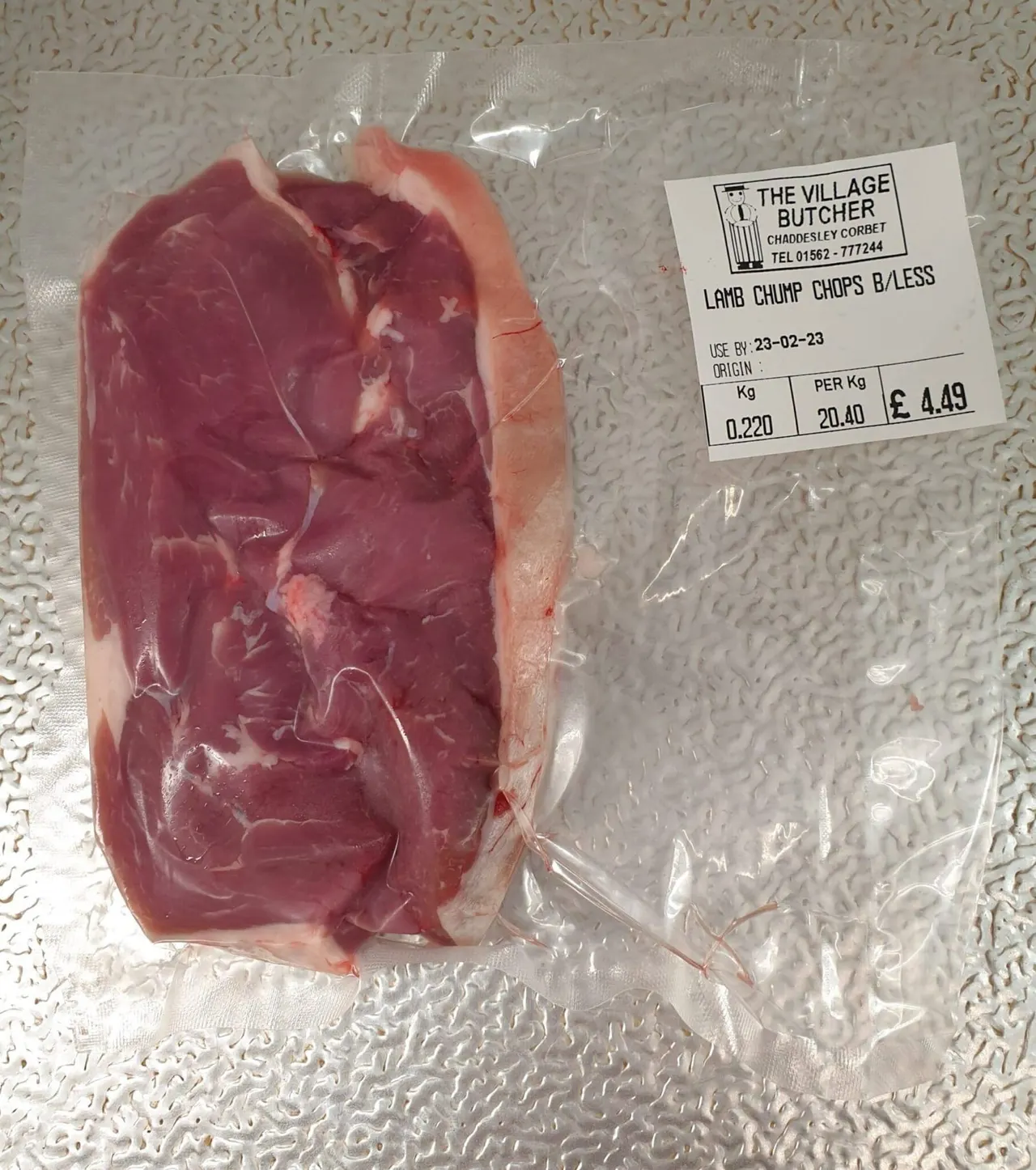 This is a designed graphic—a product label and pricing sticker on packaged meat.

Since this is a designed graphic (a butcher's label on a food product), my response is:

GRAPHIC