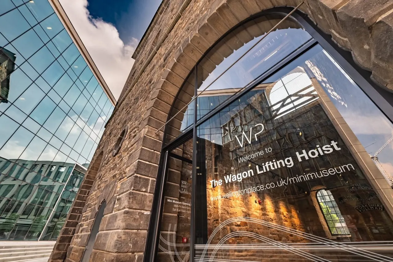 Entrance to heritage museum housed in converted Victorian industrial building with arched stone doorway and modern glass frontage.