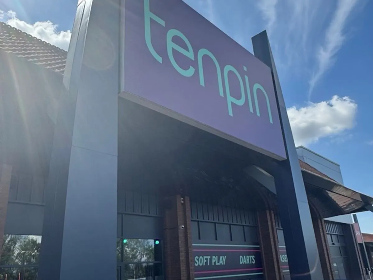 This is a PHOTOGRAPH, so I'll provide alt text:

Modern leisure venue storefront with purple and turquoise signage displaying "tenpin" and advertising soft play and darts facilities.