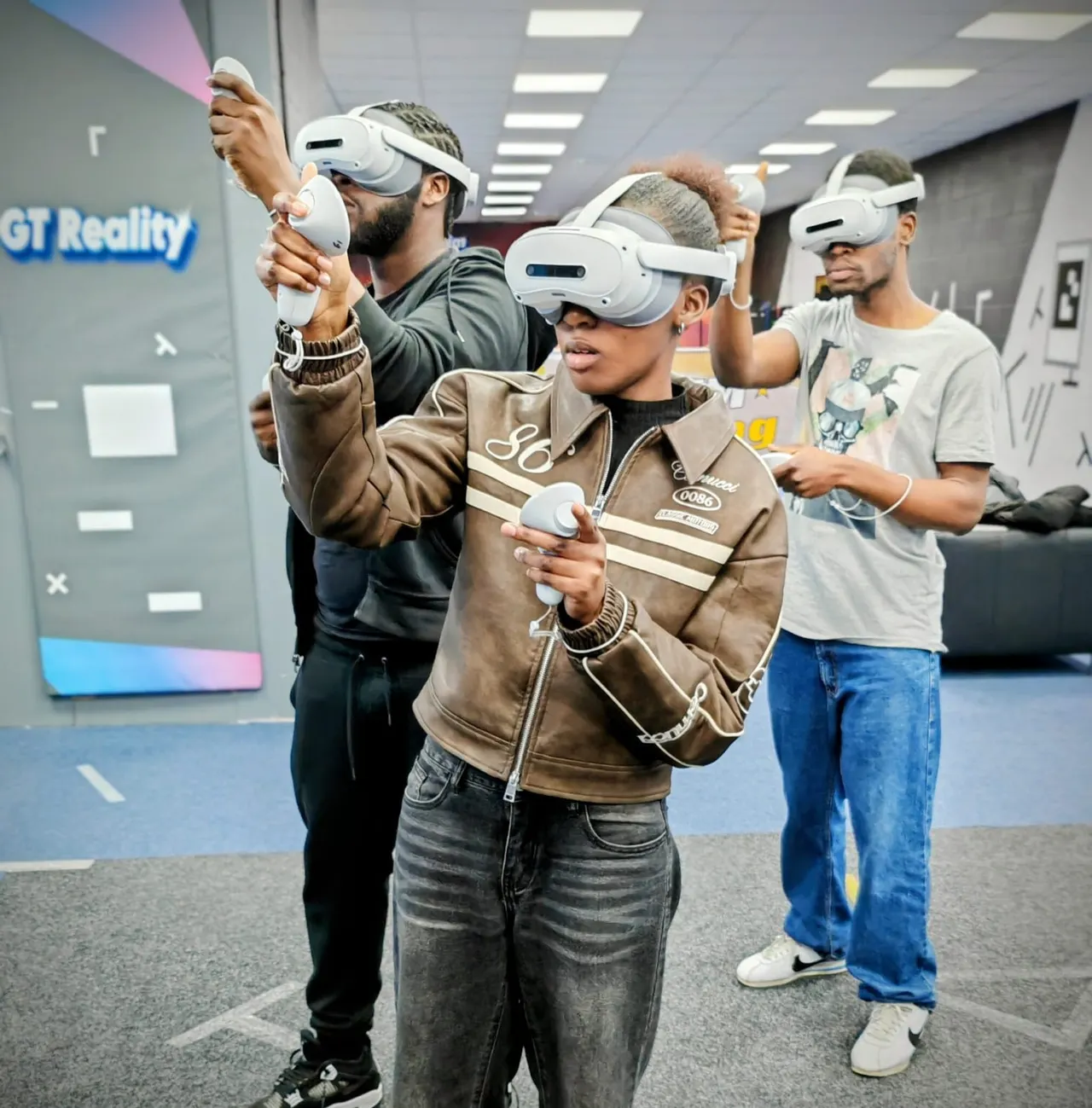 Group of visitors wearing VR headsets inside an indoor leisure facility.