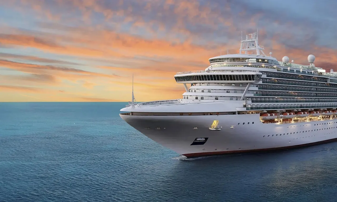 Large cruise ship on calm turquoise sea at sunset with golden sky.