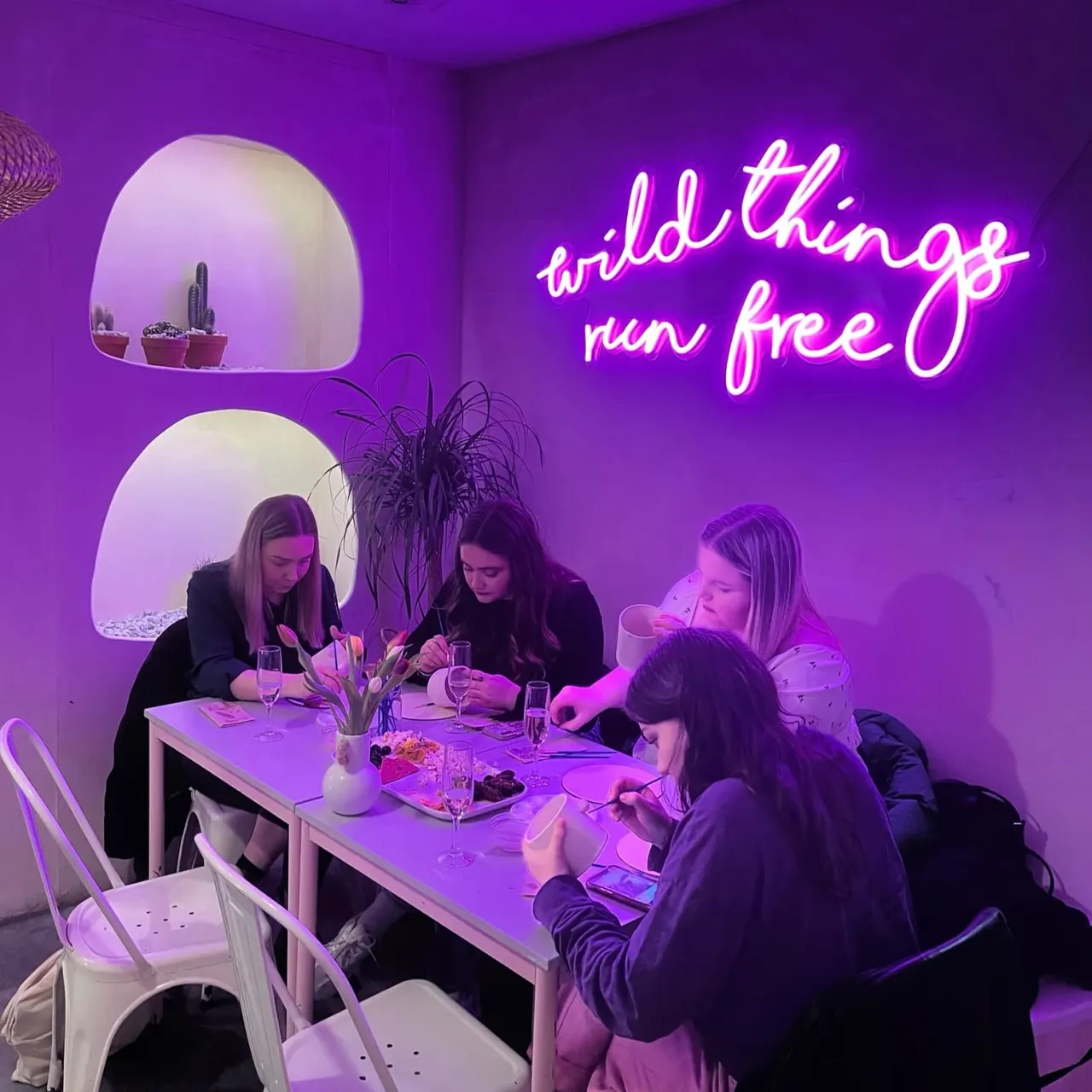 This is a designed graphic — a photo with overlaid neon text and signage.

**GRAPHIC**
