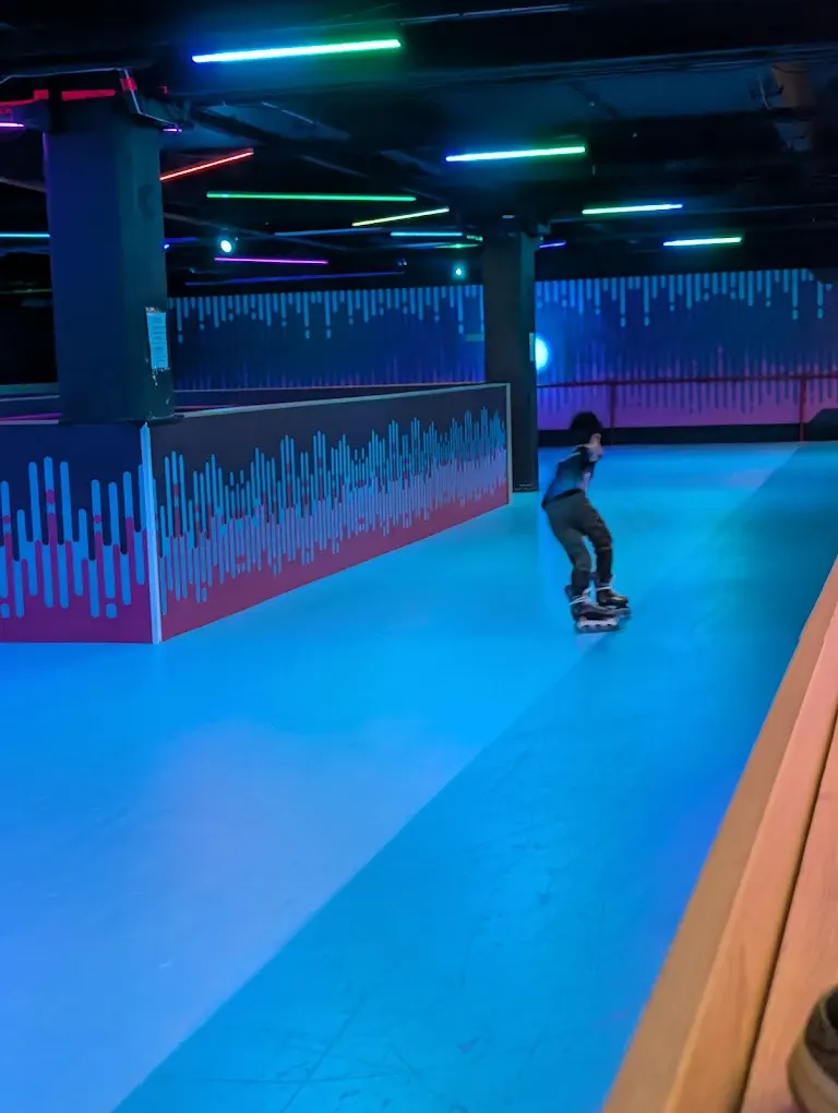 Skater on Spin Pin roller rink with neon lighting