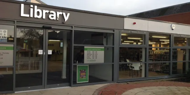 This is a designed graphic (a photograph of a building storefront with overlaid text), so my response is:
GRAPHIC