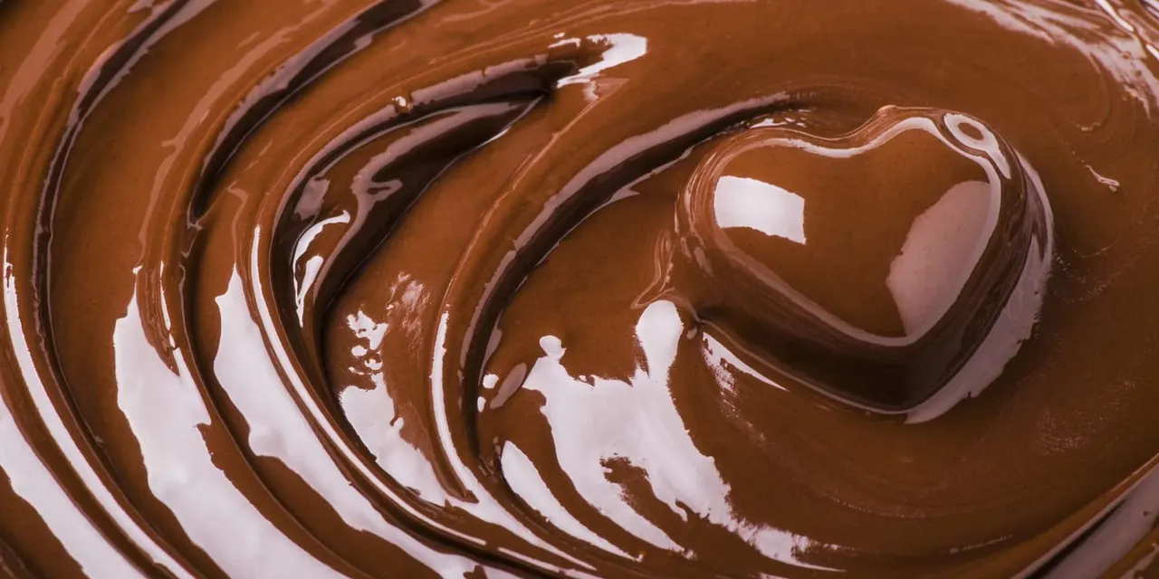 Swirled melted chocolate in shades of brown and white.