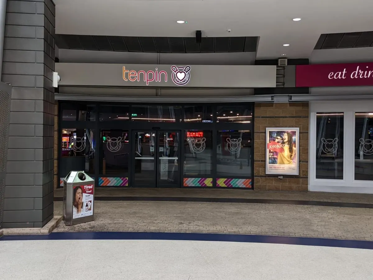 Tenpin bowling venue storefront with neon signage and glass frontage in an indoor shopping centre.