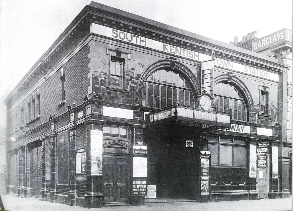 This is a PHOTOGRAPH.

South Kentish Town Underground station entrance, a Victorian-era brick building with arched windows and signage.