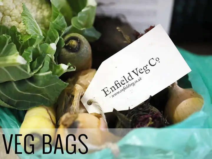 Enfield Veg Co label on a bag of fresh vegetables including cabbage, beetroot and other produce.