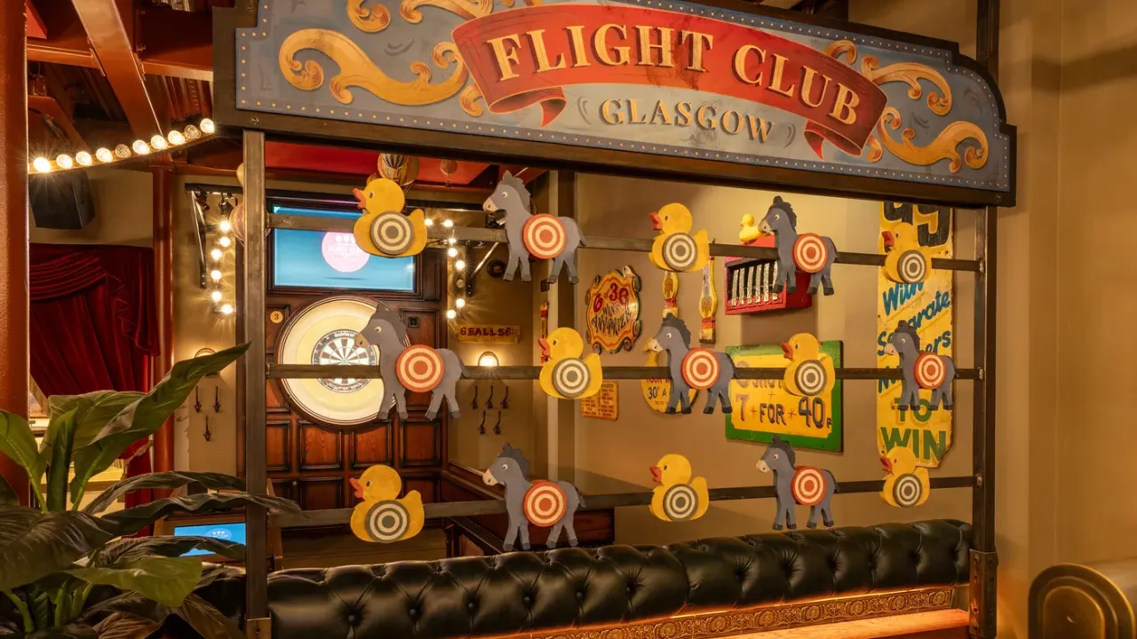 Vintage-style arcade game display with illuminated duck and horse shooting targets at Flight Club Glasgow entertainment venue.