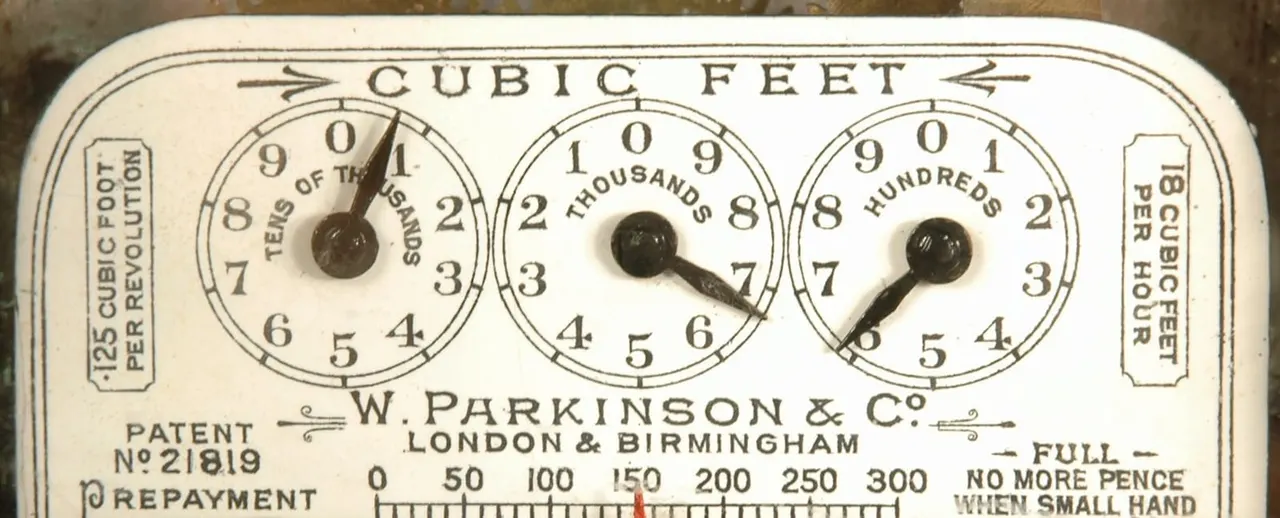 Vintage W. Parkinson & Co cubic feet meter with three dial gauges showing imperial volume measurements.