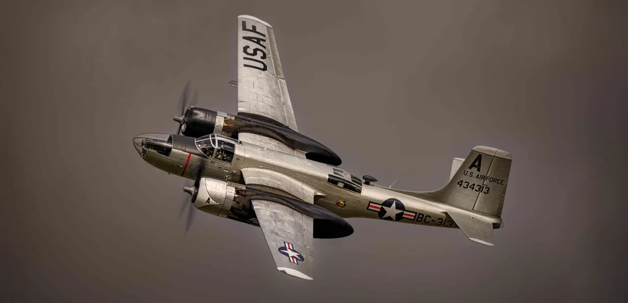 Vintage U.S. Air Force twin-engine bomber aircraft in flight against a grey sky.