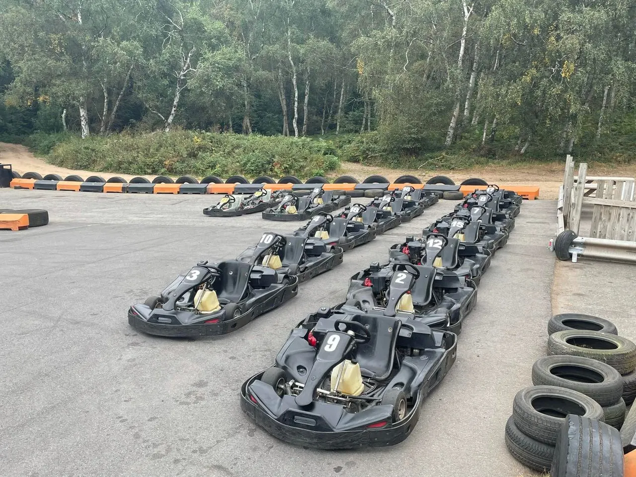 Rows of numbered 200cc Biz go-karts parked at Lockwell Hill outdoor staging area