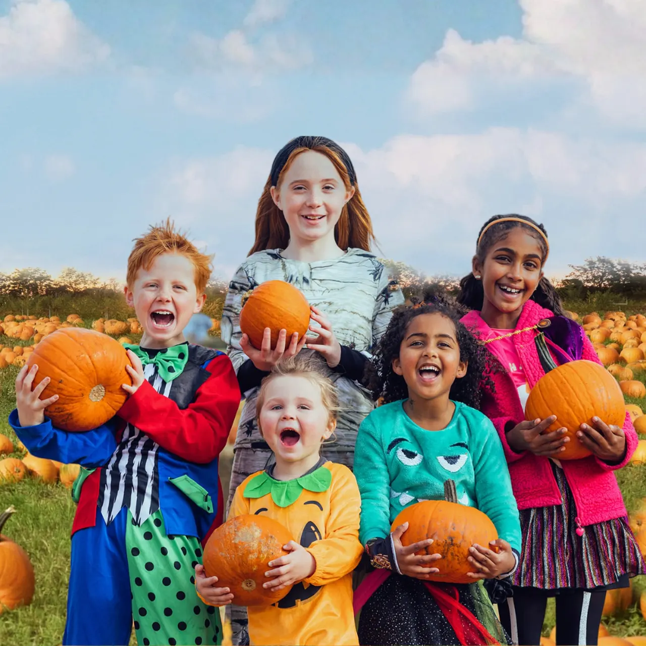 Group of six children holding pumpkins in a pumpkin patch field under blue sky.