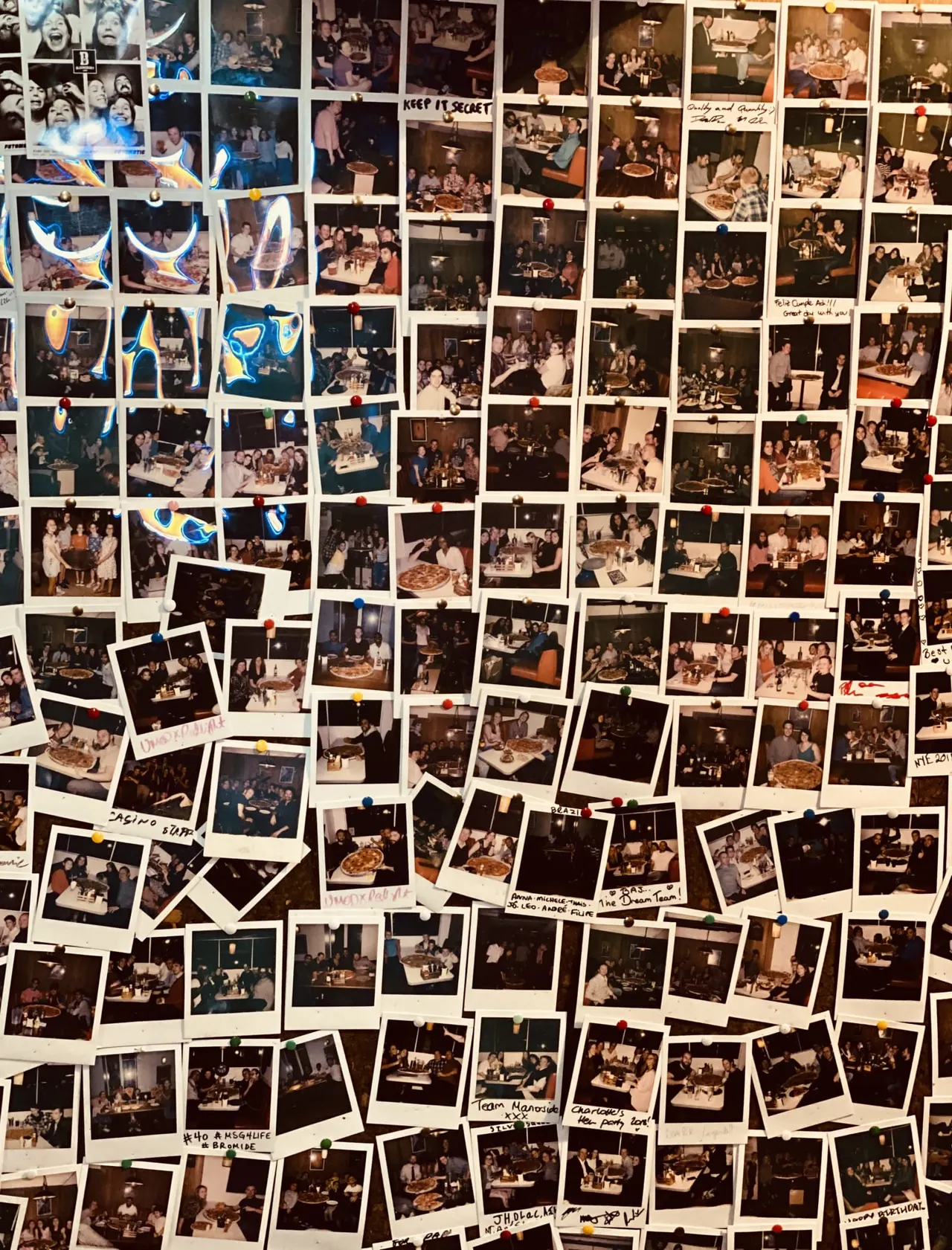 Collage of vintage photographs and graphics pinned to a wall showing groups of people dining and socialising indoors at various events.