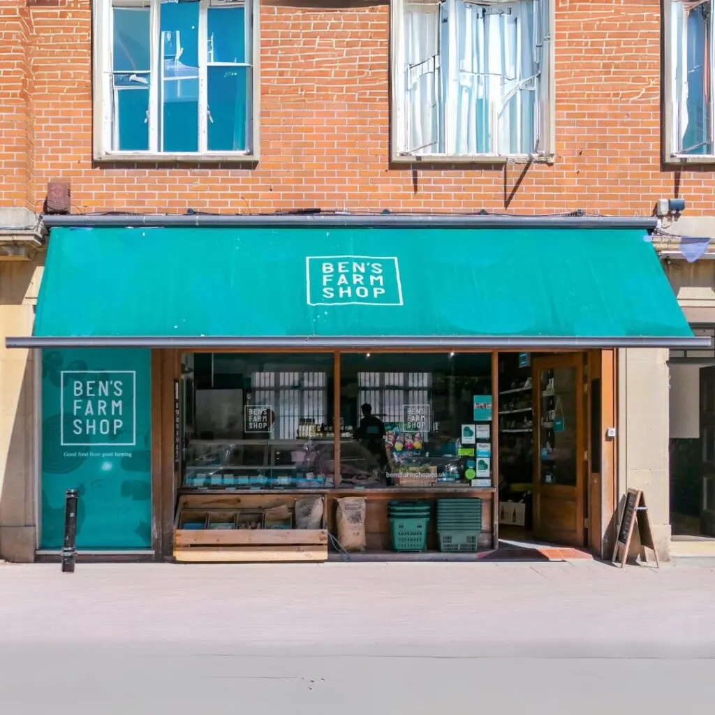 Storefront of Ben's Farm Shop with turquoise awning and brick building facade.