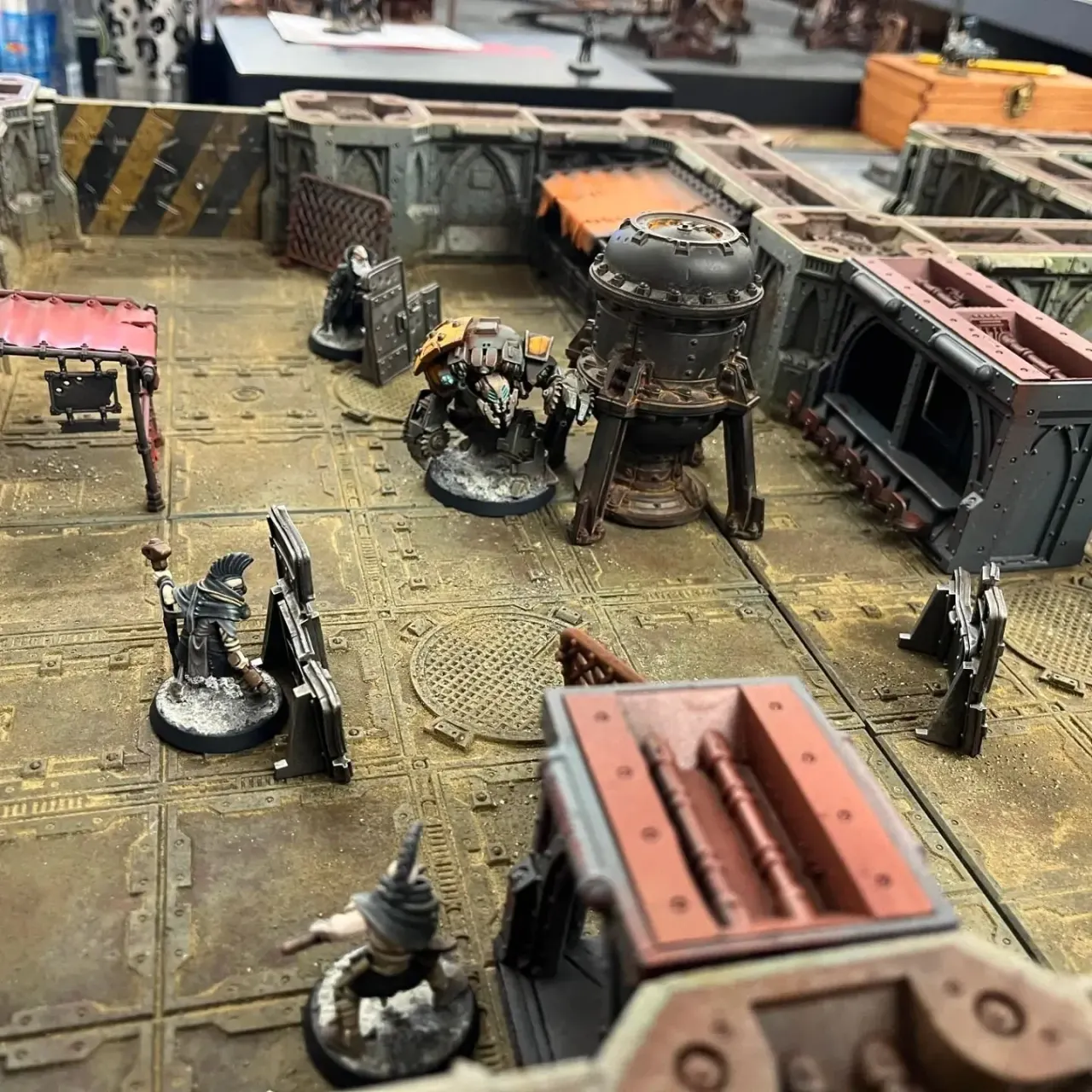 Warhammer tabletop miniature gaming scene with painted figures and terrain on a board.