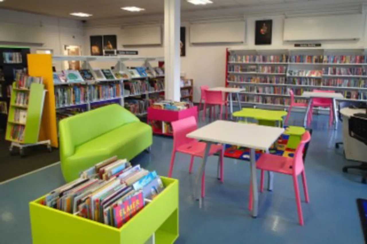 Bright children's library space with colourful furniture, bookshelves, and reading tables.