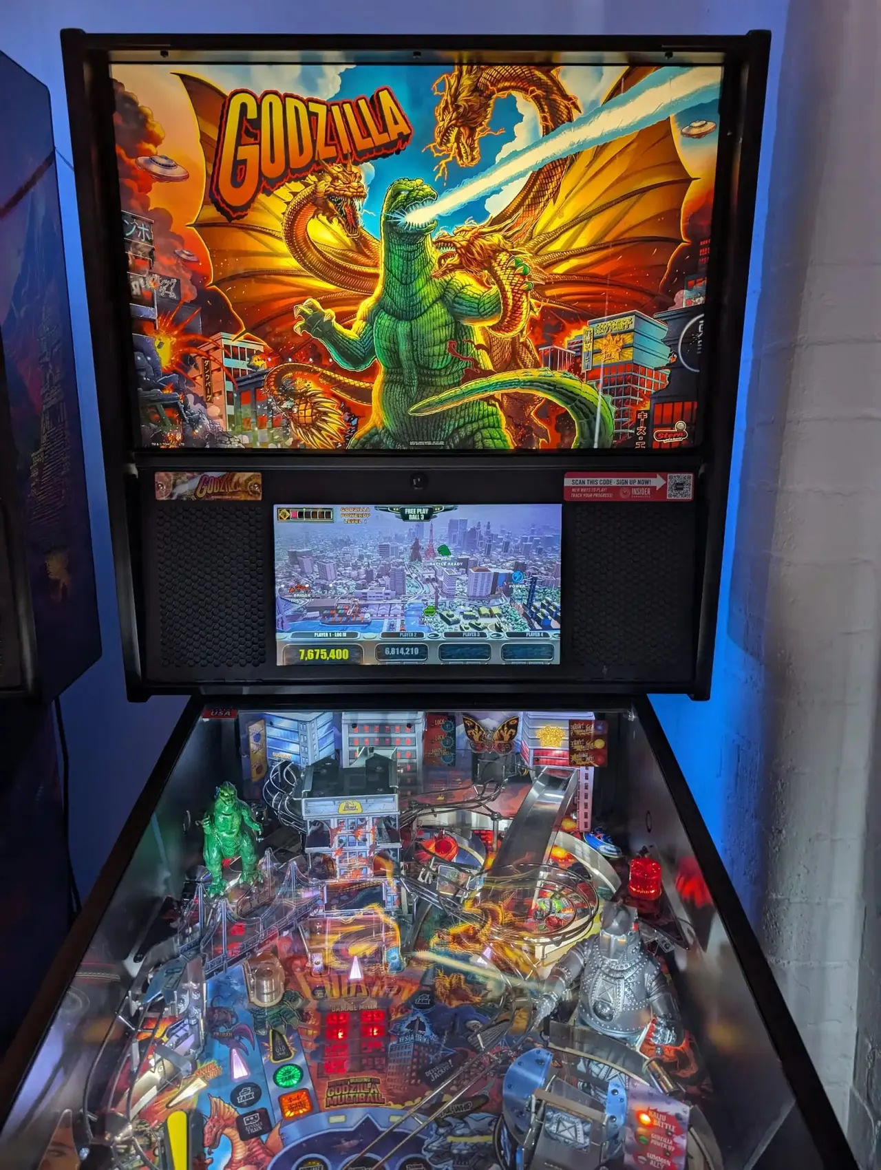 Godzilla-themed pinball machine with illuminated playfield and monster artwork on backglass.