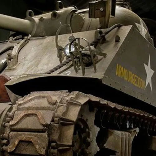 Close-up of vintage military tank turret with gun barrel and "Ammunition" marking visible.