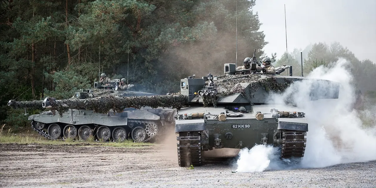 Military tanks with armed personnel conducting a demonstration exercise in a woodland setting.