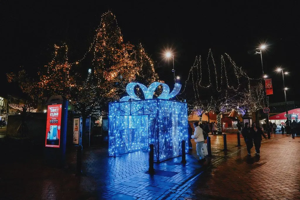 Festive covered ice rink with skaters