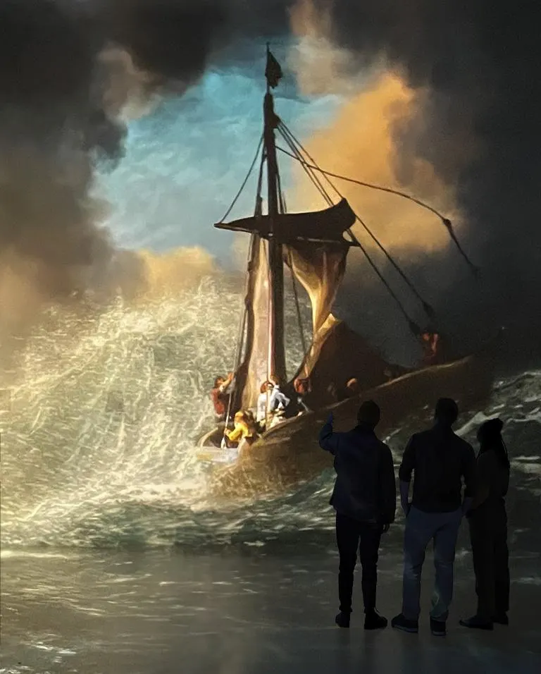 Three visitors observe a large illuminated diorama depicting a historical sailing ship in stormy seas.