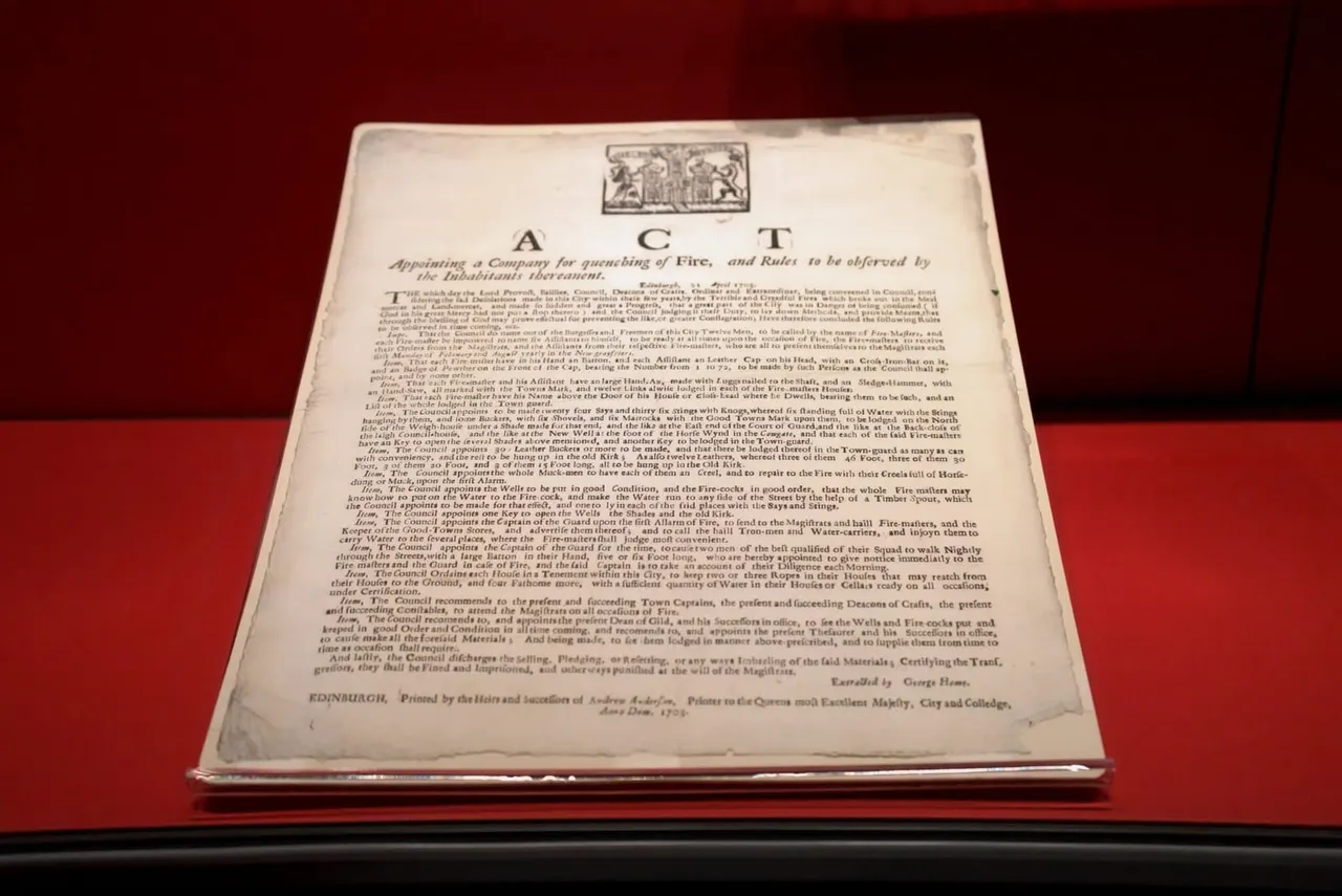 An 18th-century historical document titled "Act" regarding fire prevention and regulations, displayed under glass against a deep red background.