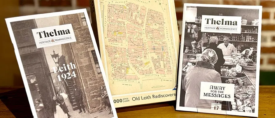 Three heritage publications about Leith displayed on a wooden surface, including historical maps and black-and-white photographs of the area.