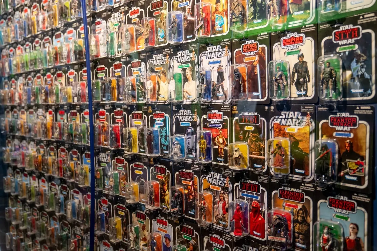 Shelves displaying a large collection of packaged Star Wars action figures in original packaging.