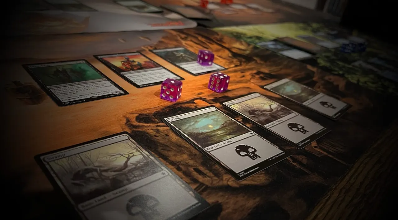 Trading cards and purple dice arranged on a wooden table during a tabletop game session.