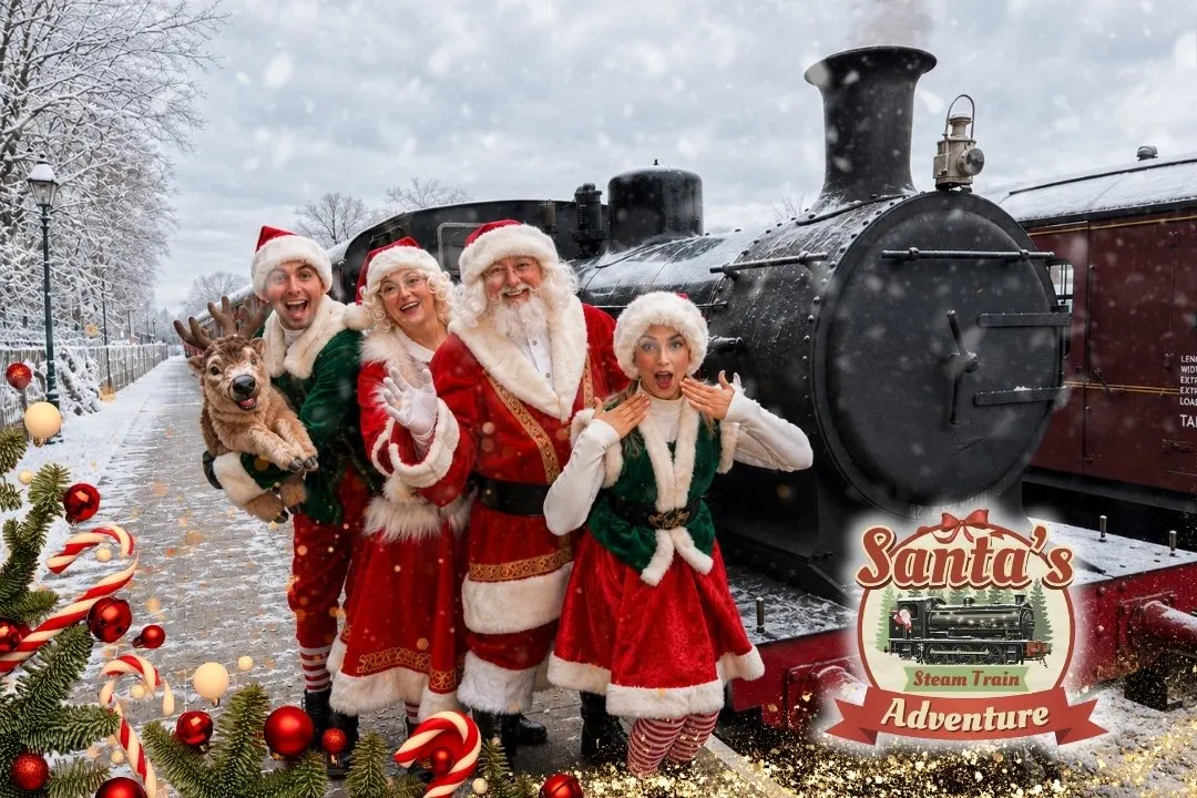 Santa, Mother Christmas and elves with steam locomotive