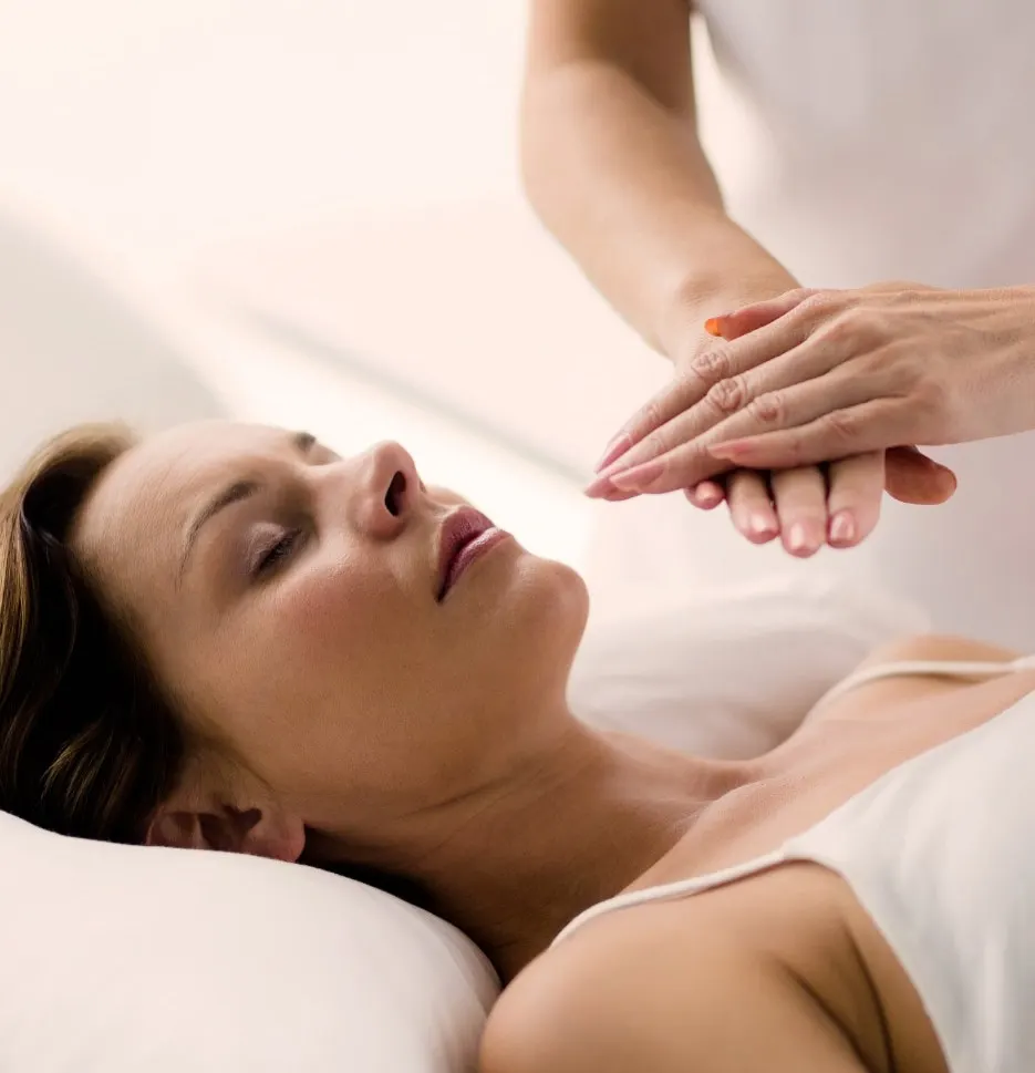 Woman receiving a relaxing massage or healing treatment on her shoulders and neck.