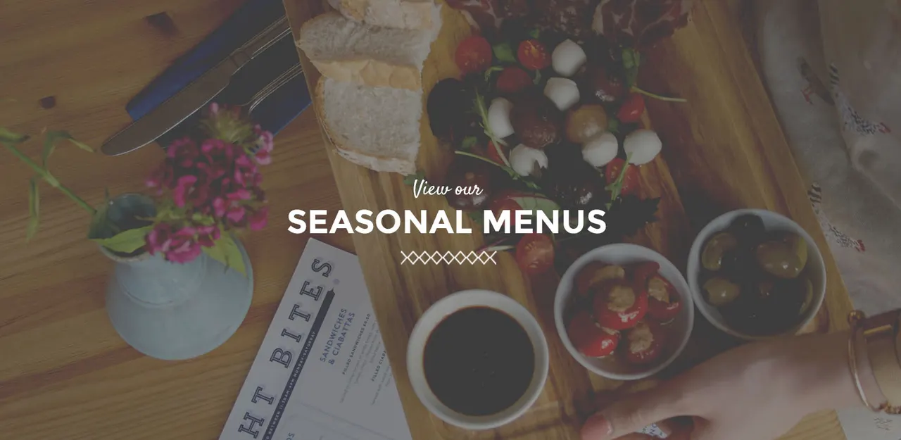 This is a designed graphic. It's a menu promotion card overlaid on a photograph of food and tableware.

GRAPHIC