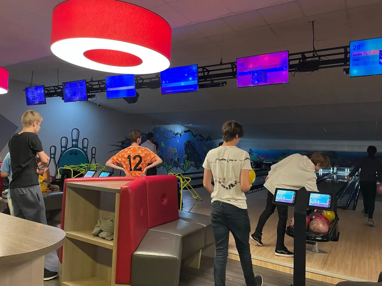 People bowling on illuminated lanes at Mansfield Superbowl